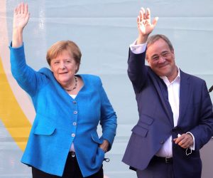 epa09486994 Christian Democratic Union (CDU) party chairman and top candidate for the upcoming federal elections Armin Laschet (R) and German Chancellor Angela Merkel (L) during the election campaign closing of the CDU in Aachen, Germany, 25 September 2021. The election for the 20th German Bundestag will take place on 26 September 2021.  EPA/FRIEDEMANN VOGEL