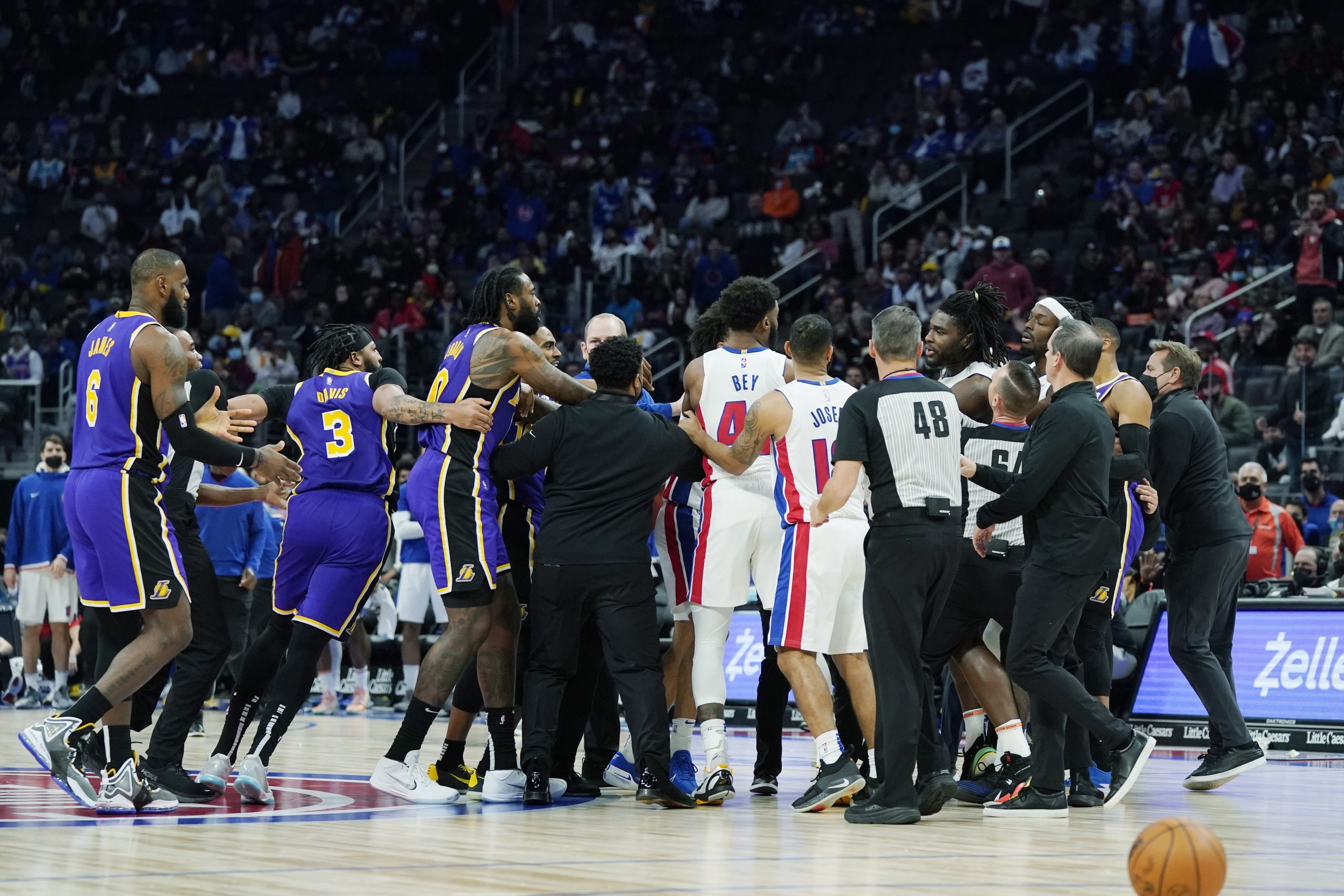 Players separate Los Angeles Lakers forward LeBron James, left, and Detroit Pistons center Isaiah Stewart, far right center, during the second half of an NBA basketball game, Sunday, Nov. 21, 2021, in Detroit. (AP Photo/Carlos Osorio)
