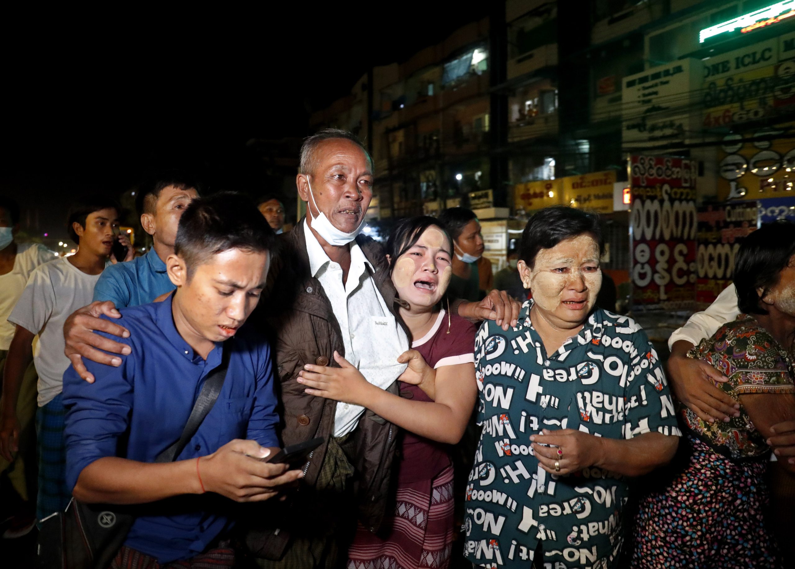 epa09530203 A released man (2-L) meets with his family members outside the Insein prison in Yangon, Myanmar, 18 October 2021. Myanmar's junta chief Min Aung Haling announced the released of over 5,000 people who were participated in the anti-coup protest. According to the Assistance Association for Political Prisoners (Burma) - AAPPB more than 7,300 are currently behind bars who are against the February 2021 coup.  EPA/STRINGER