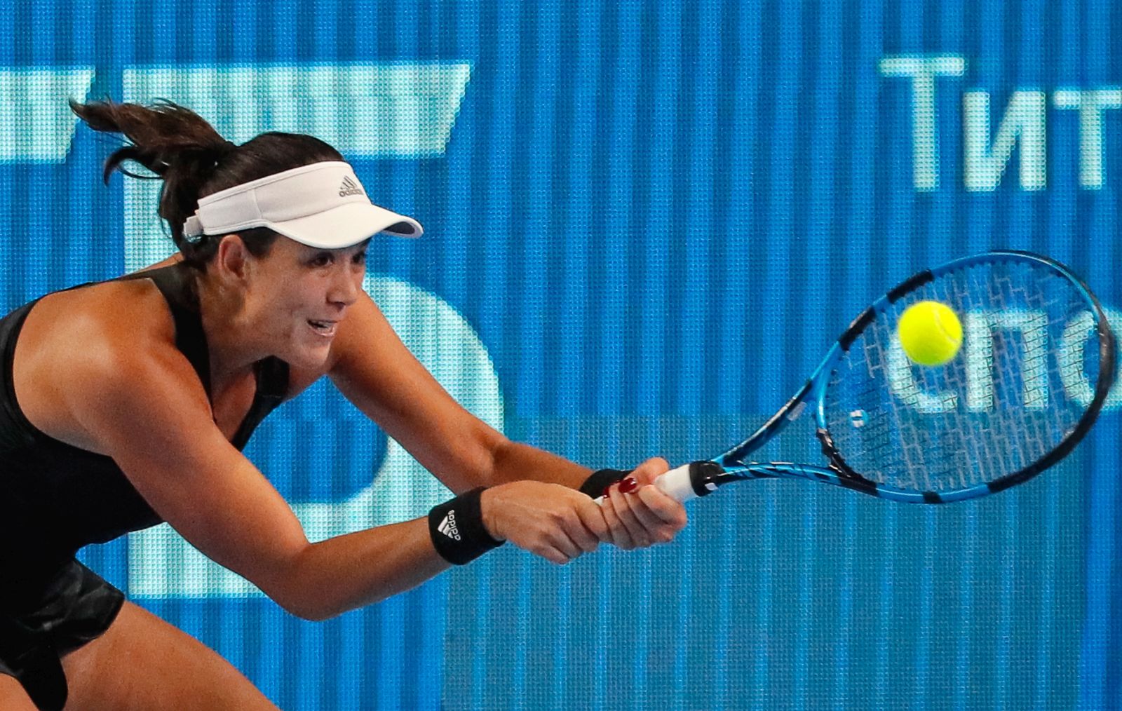 epa09533973 Garbine Muguruza of Spain in action against Tereza Martincova of the Czech Republic during their women's second round match at the Kremlin Cup tennis tournament in Moscow, Russia, 20 October 2021.  EPA/SERGEI ILNITSKY