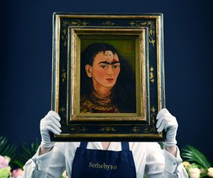 epa09535655 A Sotheby's auction house staff with Mexican artist Frida Kahlo's final 'bust' self-portrait, titled 'Diego y yo' (Diego and I), at Sotheby's in London, Britain, 21 October, 2021. Thought to be the most valuable work by the Mexican artist, the painting is estimated to fetch in excess of some USD 30 million and will go on sale in New York in November.  EPA/ANDY RAIN