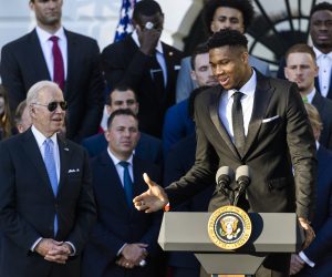 epa09571774 US President Joe Biden (L) listens to Giannis Antetokounmpo (R), forward with the NBA team the Milwaukee Bucks, as Biden welcomes the team to the White House for winning the 2021 NBA Championship, in Washington, DC, USA, 08 November 2021.  EPA/JIM LO SCALZO