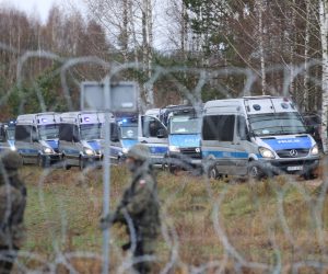 epa09572066 A handout photo made available by Belta news agency shows Polish servicemen patrolling as migrants gather on the Belarusian-Polish border in the Grodno region, Belarus, 08 November 2021 (issued 09 November 2021). According to the State Border Committee of Belarus, there are more than two thousand people near the border, including women and children, who want to obtain asylum in the European Union, 'and they do not consider the territory of the Republic of Belarus as a place of stay.' Against this background, the Polish authorities announced preparations for a breakthrough across the border. The territory is guarded by several thousand employees of the Polish special services. The migration crisis at the border of Belarus has been going on since the spring of 2021. Belarus President Alexander Lukashenko said that after the introduction of new EU sanctions against Minsk, the Belarusian authorities will no longer interfere with the movement of illegal migrants to the European Union.  EPA/LEONID SCHEGLOV / HANDOUT  HANDOUT EDITORIAL USE ONLY/NO SALES
