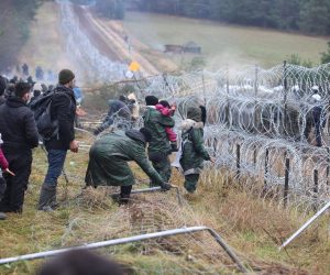 epa09572057 A handout photo made available by Belta news agency shows migrants clashing with authorities on the Belarusian-Polish border in the Grodno region, Belarus, 08 November 2021 (issued 09 November 2021). According to the State Border Committee of Belarus, there are more than two thousand people near the border, including women and children, who want to obtain asylum in the European Union, 'and they do not consider the territory of the Republic of Belarus as a place of stay.' Against this background, the Polish authorities announced preparations for a breakthrough across the border. The territory is guarded by several thousand employees of the Polish special services. The migration crisis at the border of Belarus has been going on since the spring of 2021. Belarus President Alexander Lukashenko said that after the introduction of new EU sanctions against Minsk, the Belarusian authorities will no longer interfere with the movement of illegal migrants to the European Union.  EPA/LEONID SCHEGLOV / HANDOUT  HANDOUT EDITORIAL USE ONLY/NO SALES