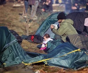 epa09572488 A handout picture made available by Belta news agency shows migrants at their camp near the Belarus-Polish border in the Grodno region, Belarus, 09 November 2021. According to the State Border Committee of Belarus (GPK), there are more than two thousand people near the border, including women and children, who want to obtain asylum in the European Union, 'and they do not consider the territory of the Republic of Belarus as a place of stay.' The territory is guarded by several thousand employees of the Polish special services. The migration crisis at the border of Belarus has been going on since the spring of 2021. Belarusian President Lukashenko said that after the introduction of new EU sanctions against Minsk, the Belarusian authorities will no longer interfere with the movement of illegal migrants to the European Union.  EPA/LEONID SCHEGLOV/BELTA HANDOUT  HANDOUT EDITORIAL USE ONLY/NO SALES