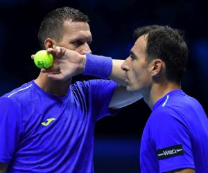 epa09582347 Ivan Dodig of Croatia and Filip Polasek of Slovakia (L) react during the doubles match against Horacio Zeballos of Argentina (R) and Marcel Granollers of Spain at the Nitto ATP Finals in Turin, Italy, 14 November 2021.  EPA/ALESSANDRO DI MARCO