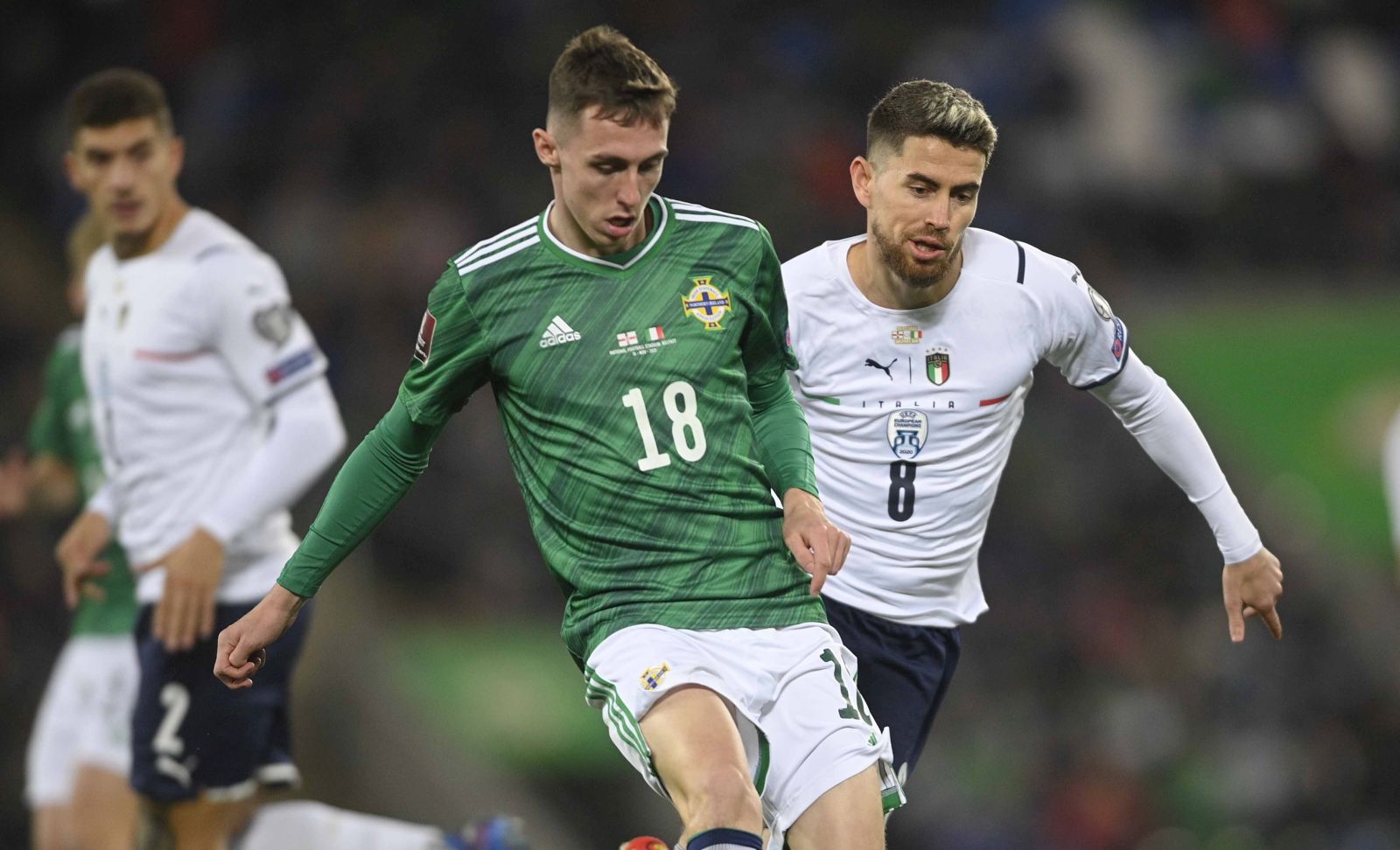 epa09583969 Northern Ireland's Gavin Whyte (L) in action against Italy's Jorginho (R) during the FIFA World Cup 2022 group C qualifying soccer match between Northern Ireland and Italy in Belfast, Britain, 15 November 2021.  EPA/MARK MARLOW