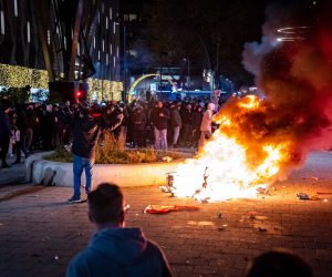 epa09592757  A scooter set on fire during a protest against the 2G policy in Coolsingel, Rotterdam, Netherlands, 19 November 2021. Hundreds of demonstrators have gathered to protest against the tightened coronavirus measures.  EPA/Killian Lindenburg