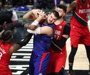 epa09573370 Los Angeles Clippers center Ivica Zubac (C-L) holds onto the ball while being guarded by Portland Trail Blazers forward Robert Covington (L) and Portland Trail Blazers center Jusuf Nurkic (R) during the second quarter of the NBA basketball game between the Los Angeles Clippers and Portland Trail Blazers at the Staples Center in Los Angeles, California, USA, 09 November 2021.  EPA/CAROLINE BREHMAN  SHUTTERSTOCK OUT