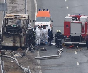 epa09598882 Fire fighters, police officers and investigators inspect the wreckage of a North Macedonia-registered bus that caught fire after crashing along a highway, killing at least 45 people, near the village of Bosnek, Bulgaria, 23 November 2021.  EPA/VASSIL DONEV