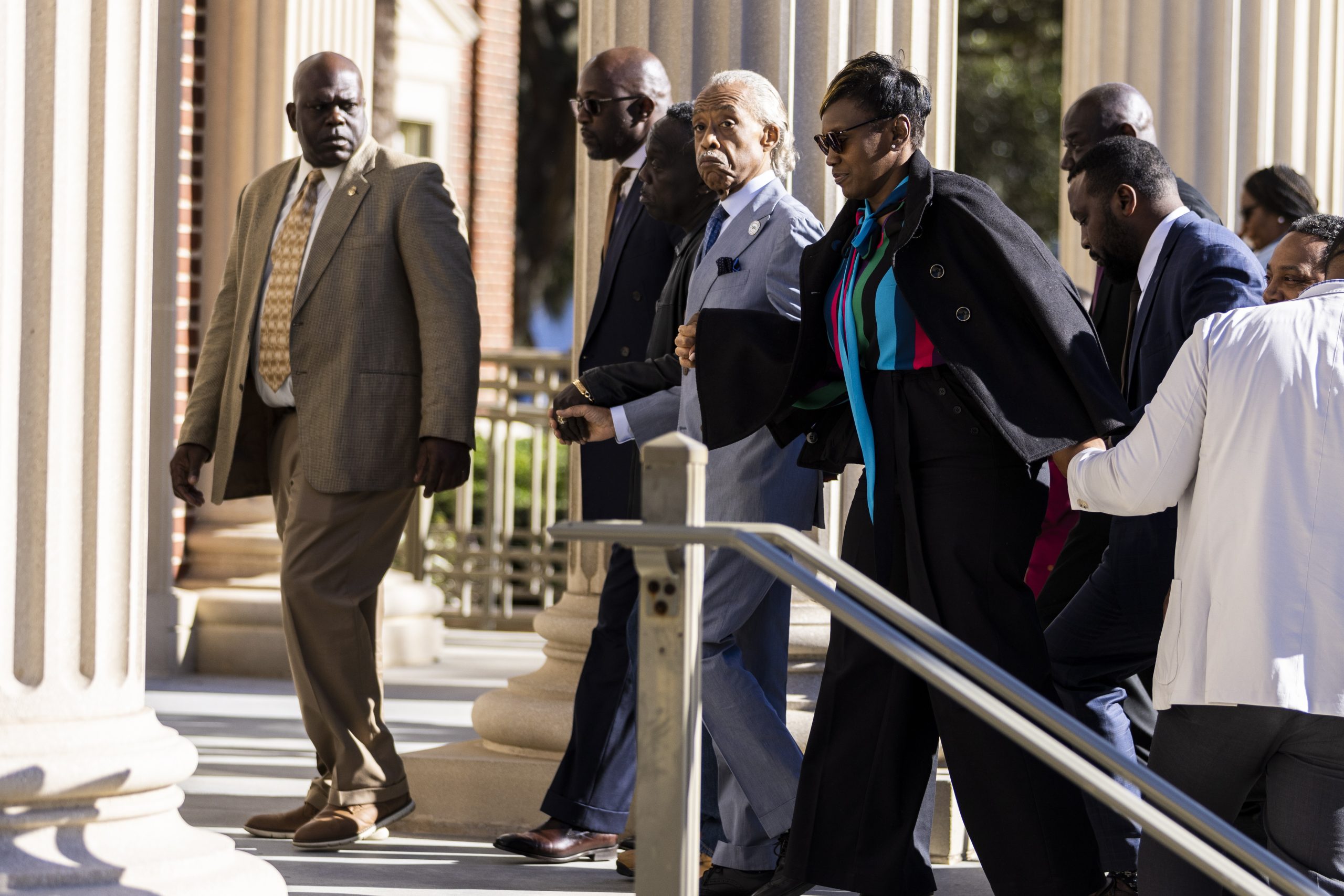 epa09600902 Al Sharpton arrives with Ahmaud Arbery's parents, Wanda Cooper-Jones (left) and Marcus Arbery (Right), at the Glynn County Courthouse as the trial of Travis McMichael, Greg McMichael and Roddie Bryan continues for the death of black jogger Ahmaud Arbery in Brunswick, Georgia, USA, 24 November 2021. Arbery died after a confrontation in the Satilla Shores neighborhood of Brunswick  on 23 February 2020.  EPA/JAMES GILBERT