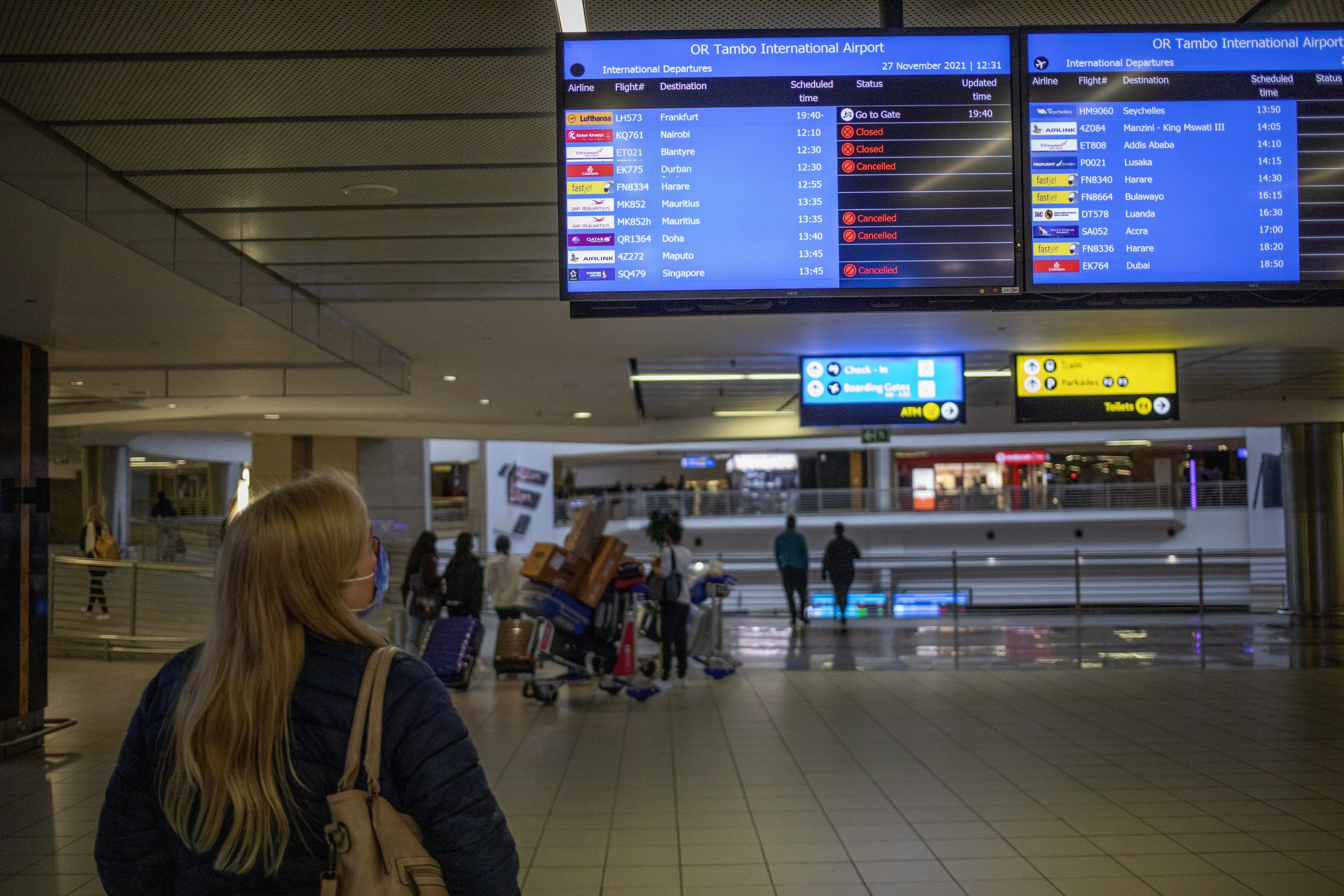 epa09606751 A flight information board shows canceled flights at OR Thambo International Airport as restrictions on international flights from South Africa start to take effect after the announcement by local scientists of the new Omicron variant, Johannesburg, South Africa, 27 November 2021. The South African Department of Health and scientists from the Network for Genomic Surveillance revealed details of a newly detected and highly mutated Covid-19 variant, B.1.1.529 which immediately led to Japan, Israel and the European Union placing stricter measures against South Africans travelling to and from their part of the world.  EPA/KIM LUDBROOK