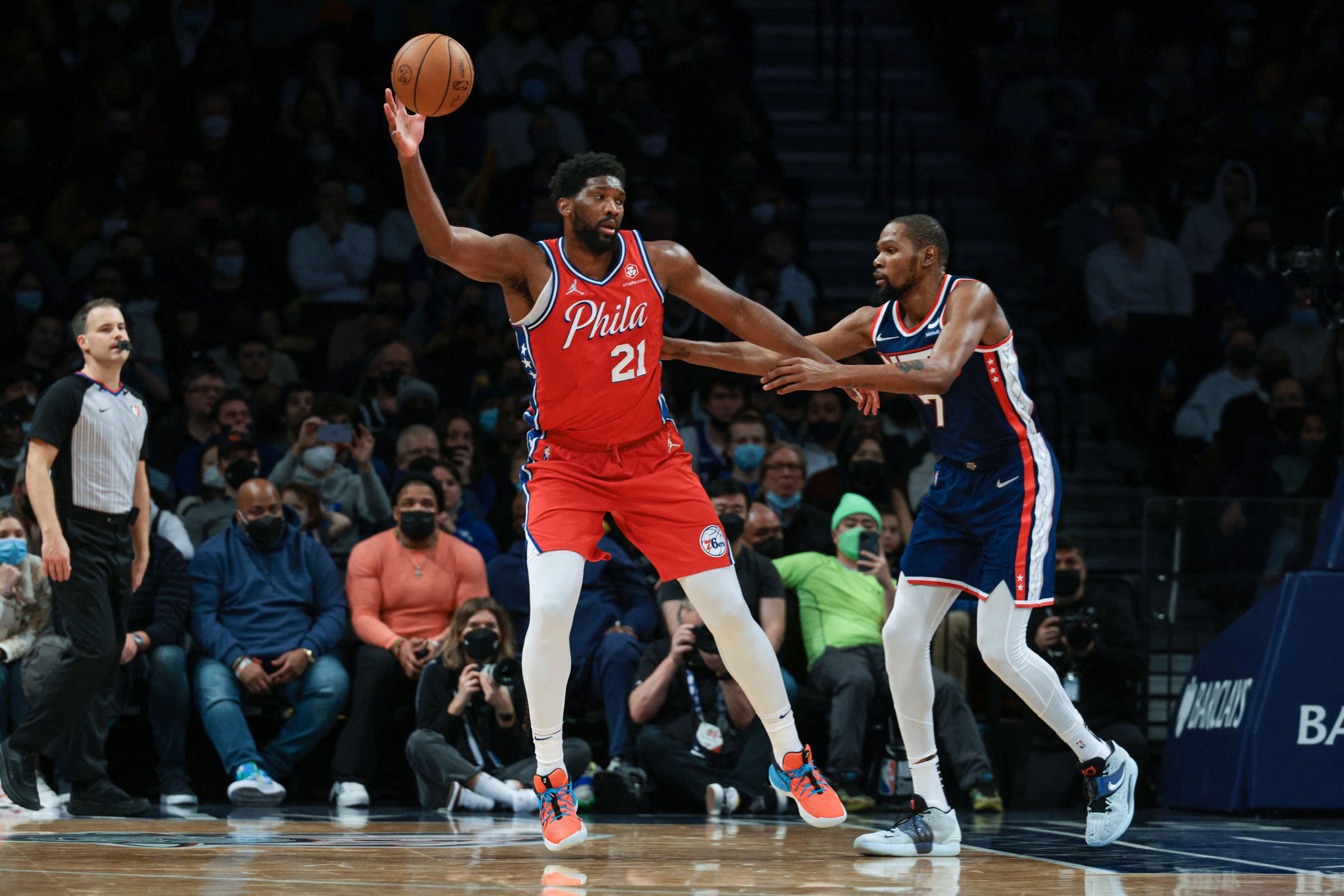 Dec 30, 2021; Brooklyn, New York, USA; Philadelphia 76ers center Joel Embiid (21) catches a pass in front of Brooklyn Nets forward Kevin Durant (7) during the second half at Barclays Center. Mandatory Credit: Vincent Carchietta-USA TODAY Sports