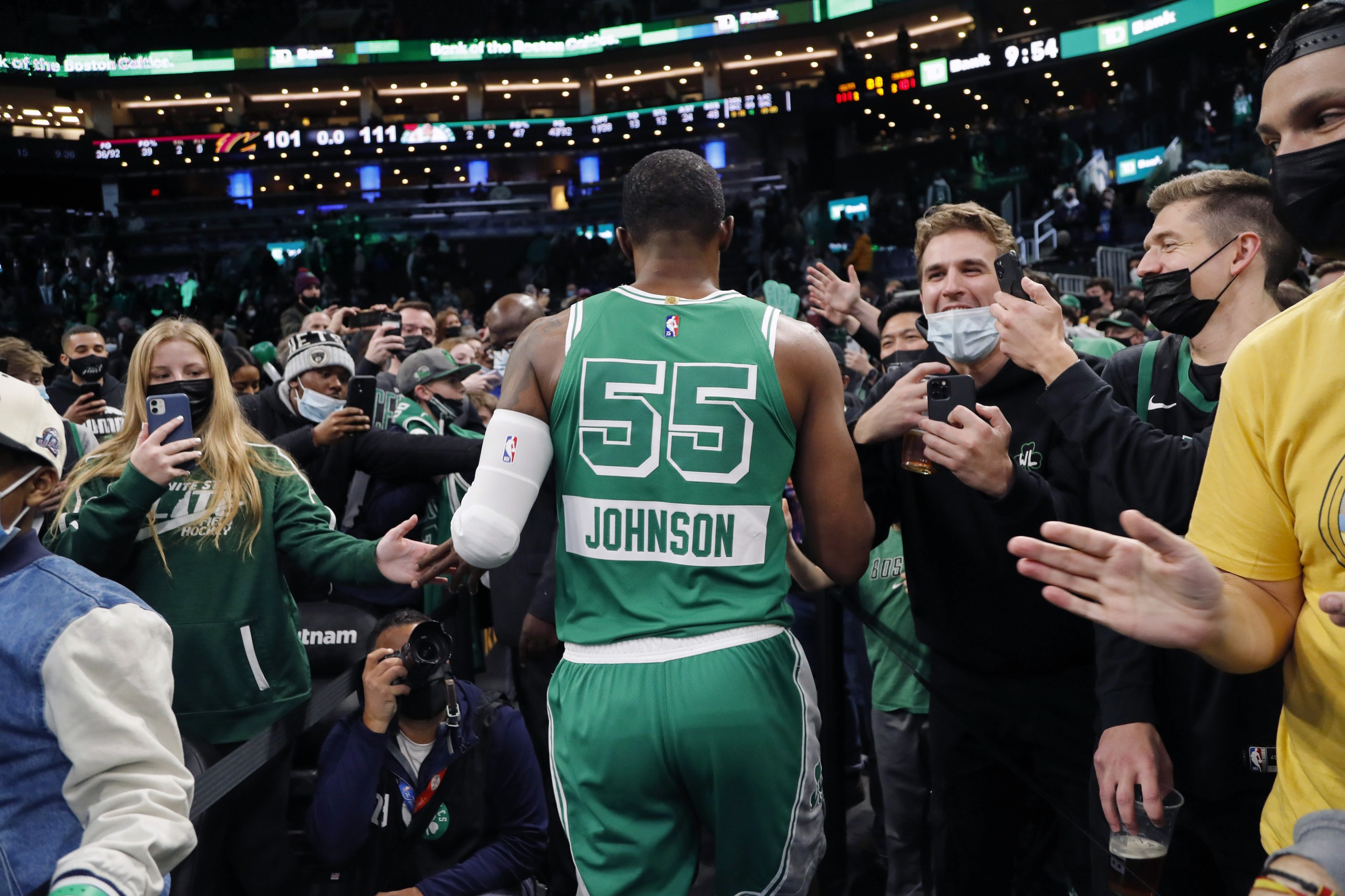 Boston Celtics' Joe Johnson is cheered by fans as he leaves the court after their win over the Cleveland Cavaliers in an NBA basketball game Wednesday, Dec. 22, 2021, in Boston. (AP Photo/Winslow Townson)
