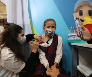 epa09598875 A nurse injects a child with a first shot of a COVID-19 vaccine in Jerusalem, Israel, 23 November 2021. Israel launched a campaign to offer Covid-19 vaccine dose for children between 5 and 12 years old  EPA/ABIR SULTAN