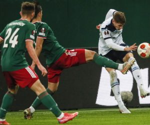 epa09603003 Maksim Nenakhov (L) and Konstantin Maradishvili (C) of Lokomotiv Moscow in action against Toma Basic (R) of Lazio during the UEFA Europa League group E soccer match between FK Lokomotiv Moscow and SS Lazio at the Lokomotiv Stadium in Moscow, Russia, 25 November 2021.  EPA/YURI KOCHETKOV