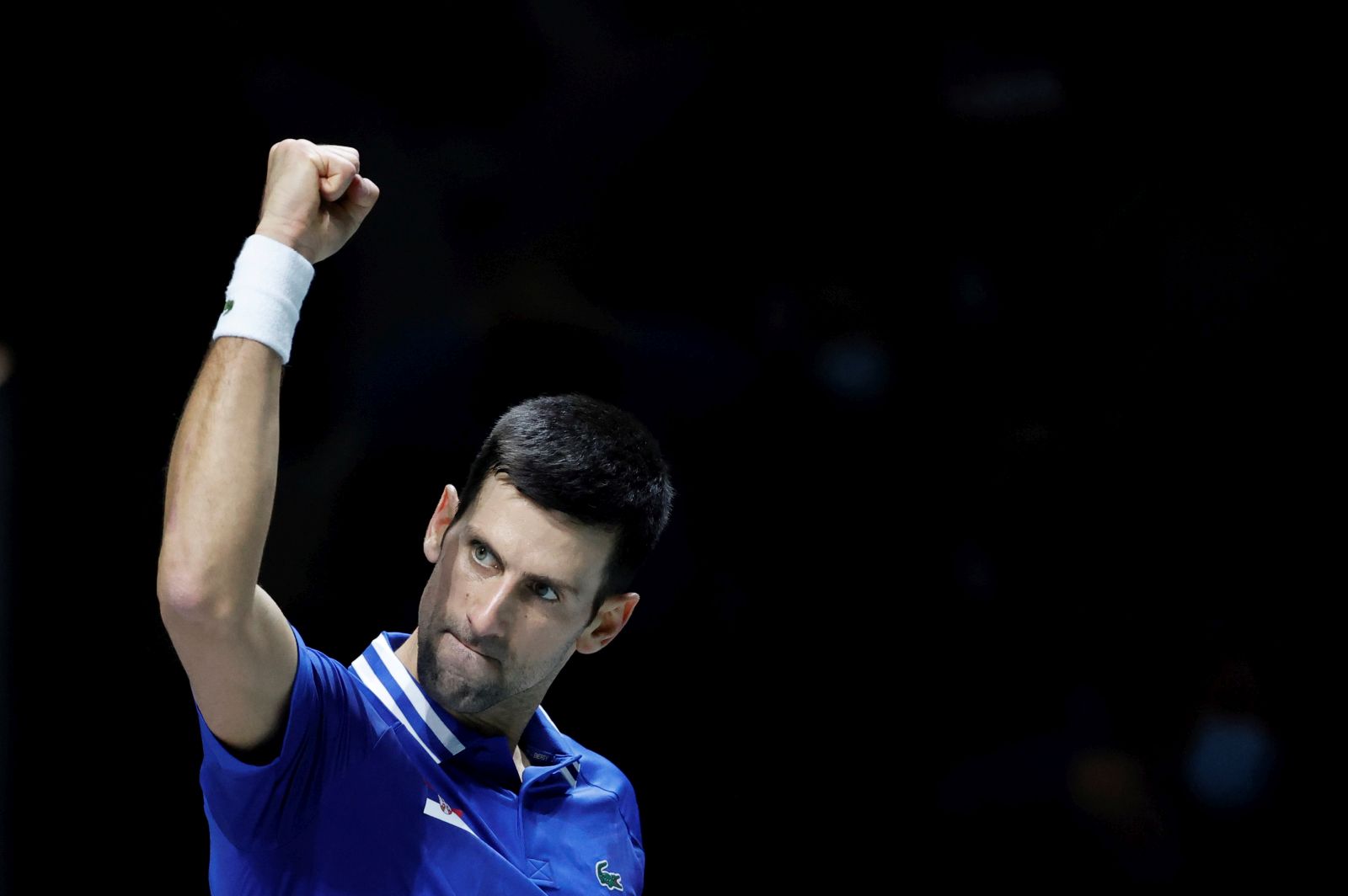 epa09619618 Novak Djokovic of Serbia celebrates winning against Marin Cilic of Croatia during their semi final Davis Cup tie between Serbia and Croatia held at Madrid Arena tennis complex in Madrid, central Spain, 03 December 2021.  EPA/Emilio Naranjo