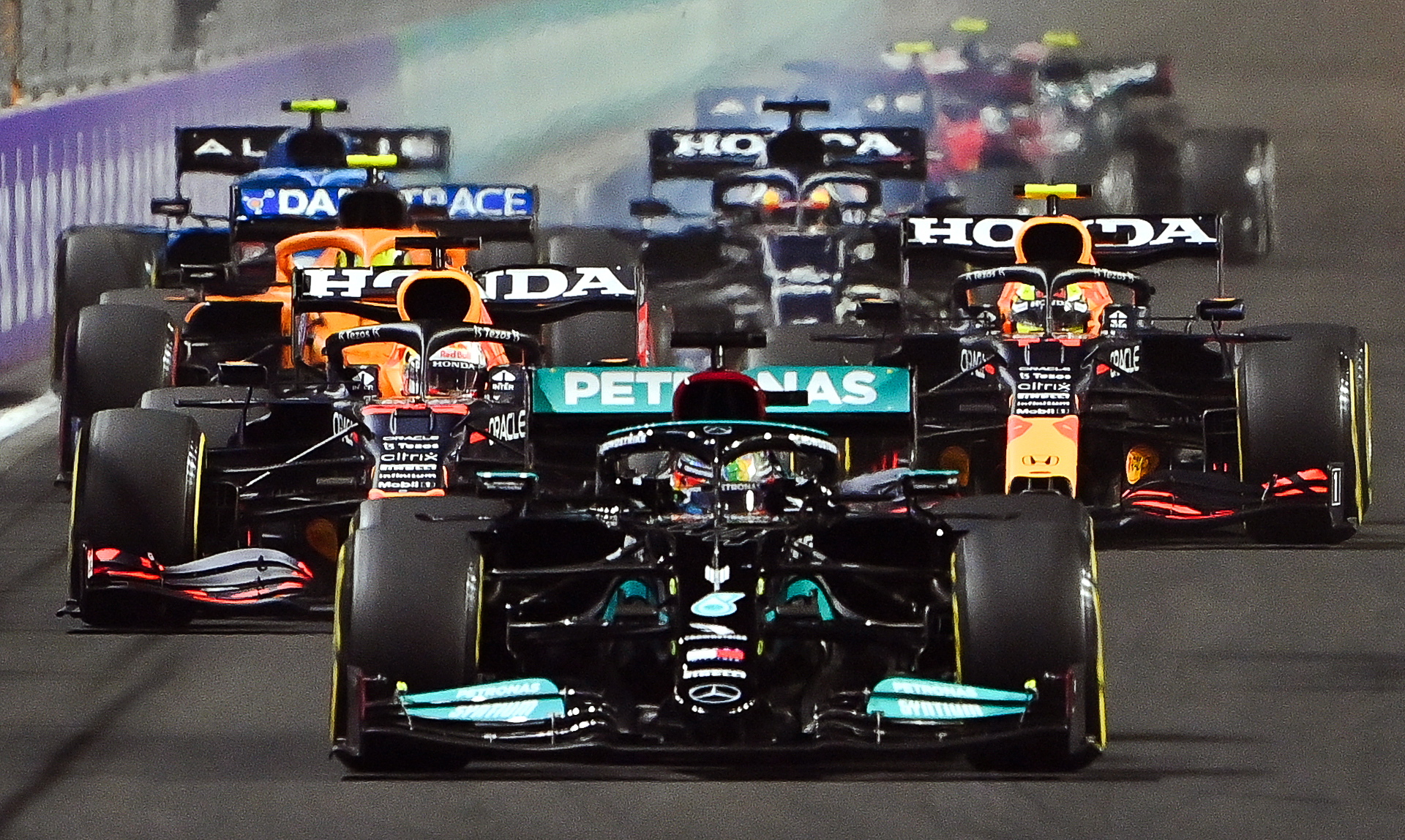 epa09624652 British Formula One driver Lewis Hamilton (front) of Mercedes-AMG Petronas is on his way to win the inaugural 2021 Formula One Grand Prix of Saudi Arabia at the Jeddah Corniche Circuit in Jeddah, Saudi Arabia, 05 December 2021.  EPA/STR