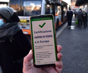 epa09625357 A valid Green Pass for Italy and EU the is diplayed on a smartphone while Italian Police and staff of AMT are checking the QR code confirming that people received the Covid-19 vaccine, at Brignole bus stop in Genoa, Italy, 06 December 2021. The measures on the 'enhanced' green certificate (obtainable only with vaccination or recovery) come into effect from 06 December 2021 until 15 January 2022.  EPA/LUCA ZENNARO