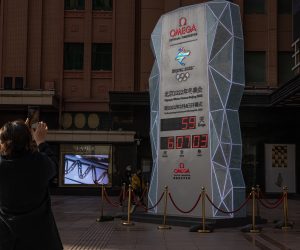 epa09626624 A woman stands in front of a countdown display showing days left for the Beijing 2022 Winter Olympics, on a shopping street in Beijing, China, 07 December 2021. US officials announced a diplomatic boycott of the 2022 Beijing Winter Olympics as a result of as it described ongoing genocide and crimes against humanity in Xinjiang and other human rights abuses in China. US athletes would still be taking part in the Games. The 2022 Beijing Winter Olympics is scheduled to begin in less than two months.  EPA/ROMAN PILIPEY
