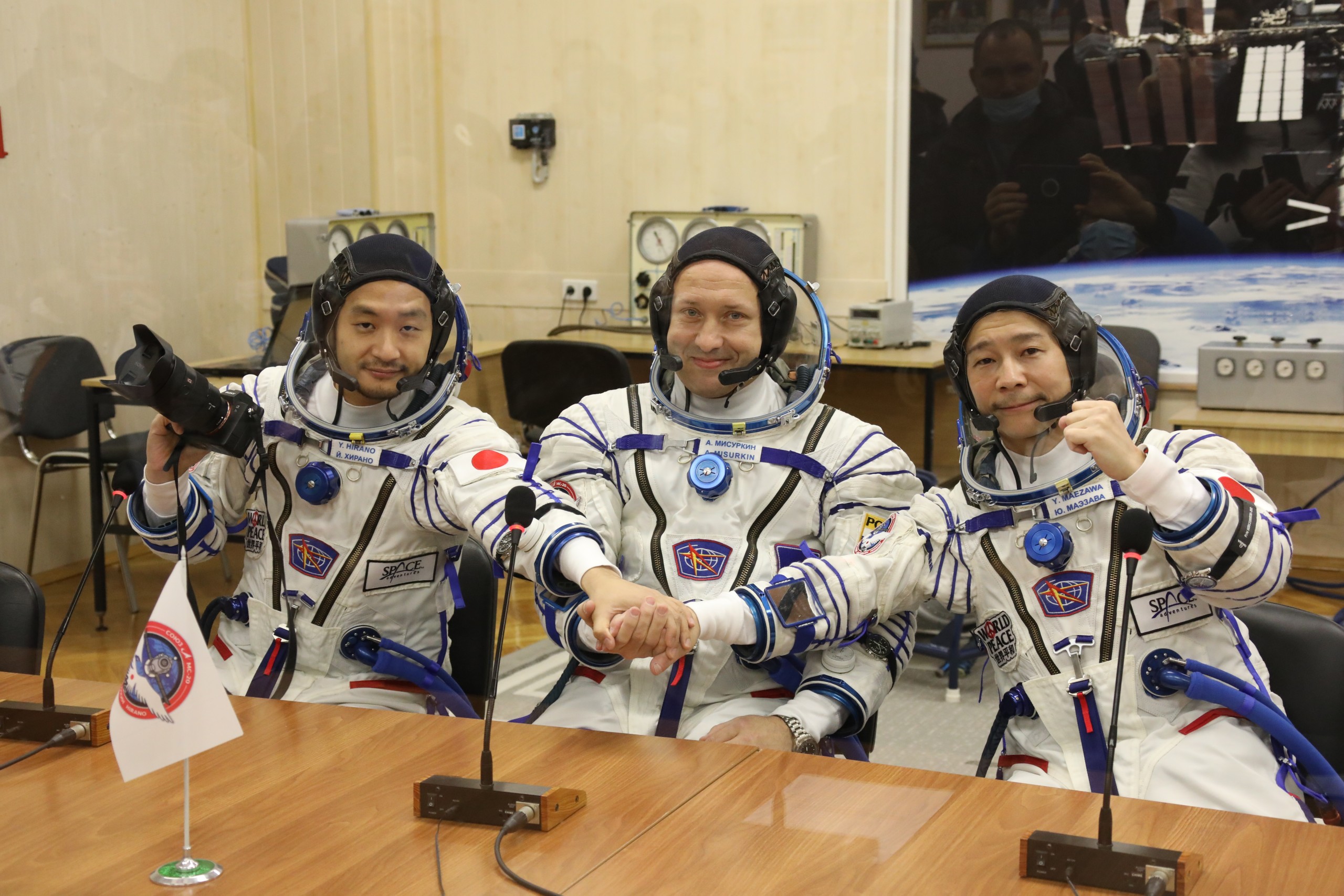 epa09628875 A handout photo made available by the official website of the Russian State Space Corporation ROSCOSMOS shows members of the main crew of the new Soyuz mission to the International Space Station (ISS) Roscosmos cosmonaut Alexander Misurkin (C), space flight participants Yusaku Maezawa (R) and Yozo Hirano (L) after their space suits check shortly before the launch at the Russian leased Baikonur cosmodrome, Kazakhstan, 08  December 2021. Japanese entrepreneur Yusaku Maezawa and his production assistant Yozo Hirano, led by Roscosmos cosmonaut Alexander Misurkin, will take part in a mission to the International Space Station (ISS) scheduled for 08 December 2021.  EPA/ROSCOSMOS PRESS SERVICE HANDOUT  HANDOUT EDITORIAL USE ONLY/NO SALES