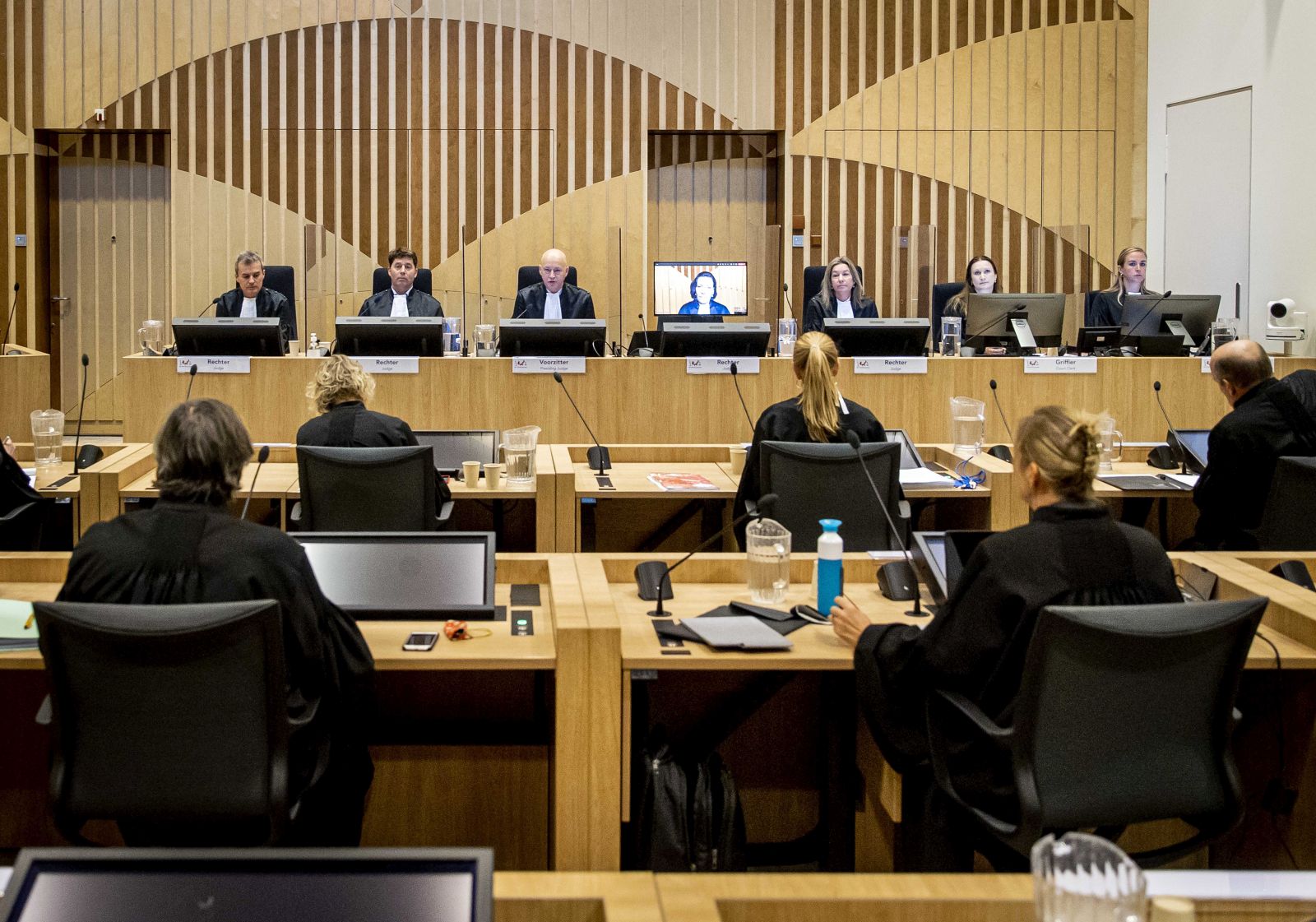 epa09629608 Prosecutors and the court including chairman Hendrik Steenhuis (3L) prior to the follow-up hearing in the Schiphol Judicial Complex for the follow-up hearing of the extensive criminal trial about the downing of flight MH17 in Badhoevedorp, the Netherlands, 08 December 2021 . Among other things, the planning and claims of injured parties are discussed during the hearing. Malaysia Airlines Flight MH-17 was shot down on 17 July 2014 while flying over eastern Ukraine, killing all 283 passengers and 15 crew on board.  EPA/SEM VAN DER WAL