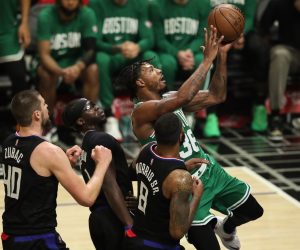 epa09630874 Boston Celtics guard Marcus Smart (R) drives to the basket hole being guarded by (L-R) Los Angeles Clippers center Ivica Zubac, Los Angeles Clippers guard Reggie Jackson and Los Angeles Clippers forward Marcus Morris Sr. during the third quarter of the NBA basketball game between the Los Angeles Clippers and Boston Celtics at the Staples Center in Los Angeles, California, USA, 08 December 2021.  EPA/CAROLINE BREHMAN  SHUTTERSTOCK OUT