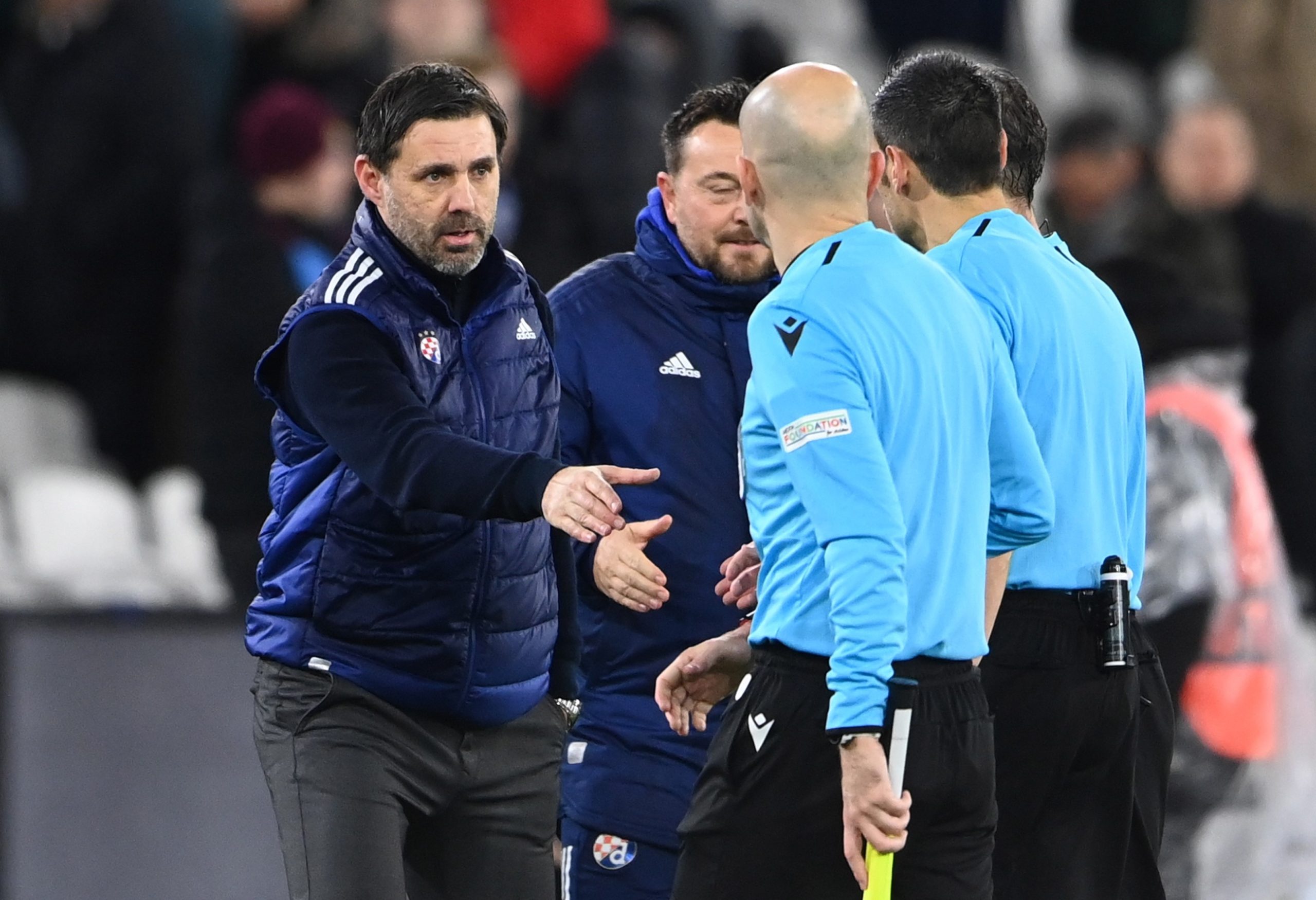 epa09632856 Dinamo Zagreb coach Zeljko Kopic shake hands with the referees after the UEFA Europa League Group H match between West Ham United and Dinamo Zagreb in London, Britain, 09 December 2021.  EPA/ANDY RAIN