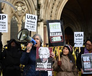 epa09633545 Julian Assange's supporters outside the High Court in London, Britain, 10 December 2021. Britain's High Court is set to rule on Julian Assange's U.S extradition hearing in London 10 December. The US government is appealing against a British judge's decision to block the extradition of WikiLeaks founder to face trial for publishing military secrets.  EPA/ANDY RAIN