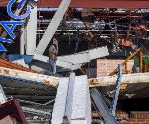 epa09637213 A resident observes damage to a business after a deadly tornado struck in Mayfield, Kentucky, USA, 11 December 2021. As many as 70 people are feared dead in Kentucky due to the tornado outbreak, according to Kentucky Governor Andy Beshear.  EPA/ADDISON LEBOUTILLIER