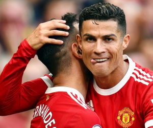 epa09620895 Bruno Fernandes of Manchester United (L) is being congratulated by teammate Cristiano Ronaldo after scoring his team's third goal during the English Premier League soccer match between Manchester United and Newcastle United in Manchester, Britain, 11 September 2021.  EPA/PETER POWELL EDITORIAL USE ONLY *** Local Caption *** 57166936