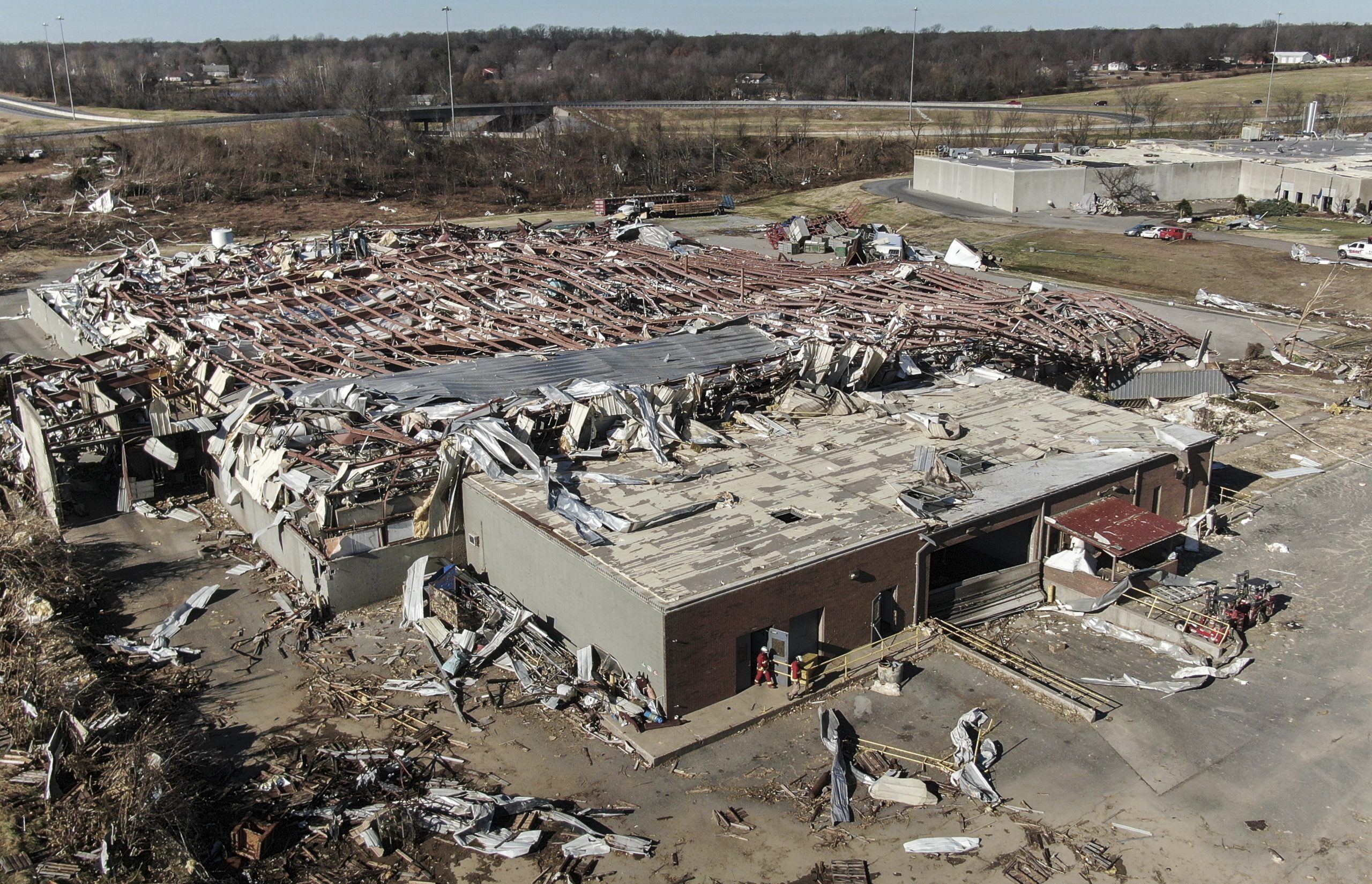 epa09638905 An aerial photo made with a drone shows the destruction of the Mayfield Consumer Products candle factory after tornadoes moved through the area leaving destruction and death across six states, in Mayfield, Kentucky, USA, 12 December 2021. According to reports more than 70 people lost their lives in Kentucky with more dead in Arkansas in the storms on 10 December.  EPA/TANNEN MAURY