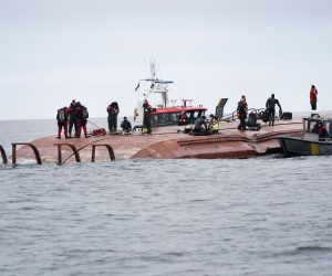 epa09640210 A view of Sea rescue members over the hull of the capsized Danish cargo ship Karin Hoej after it collided with the British cargo ship Scot Carrier in the Baltic Sea, between the Swedish town of Ystad on Sweden's southern coast and the Danish island of Bornholm, 13 December 2021. According to a statement released by the Swedish Sea Rescue Society, at least two people are feared missing after two cargo ships collided in the Baltic Sea off the Swedish coast early on 13 December. The cause of the accident is yet unknown. The Karin Hoej had capsized in the accident and was upside down.  EPA/JOHAN NILSSON  SWEDEN OUT