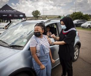epa09642812 A teenager receives a jab of Covid-19 vaccine at a drive-through vaccination facility at the Zwartkops Raceway in Pretoria, South Africa, 15 December 2021. The facility opened in an effort to increase vaccinations prior to the start of the annual end of year holidays, amid Omicron variant fears.  EPA/Kim Ludbrook