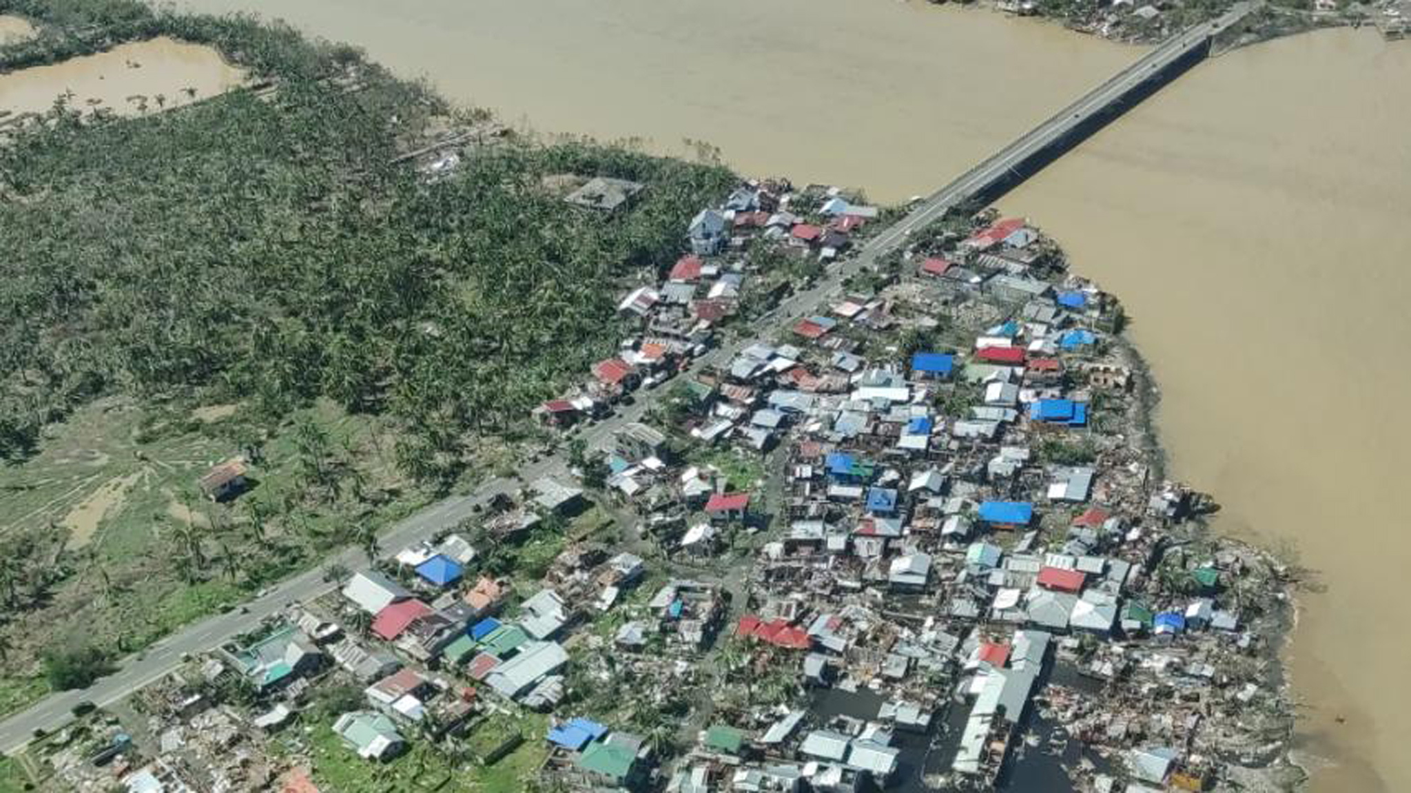 epa09646324 A handout picture made available by the Philippine Coast Guard (PCG) shows an aerial view of a typhoon-affected village in Siargao island, southern Philippines, 17 December 2021. According to the National Disaster Risk Reduction and Management Council (NDRRMC), at least six people have died and closed to 200,000 others living along the path of Typhoon Rai were evacuated.  EPA/PHILIPPINE COAST GUARD HANDOUT -- BEST QUALITY AVAILABLE -- HANDOUT EDITORIAL USE ONLY/NO SALES