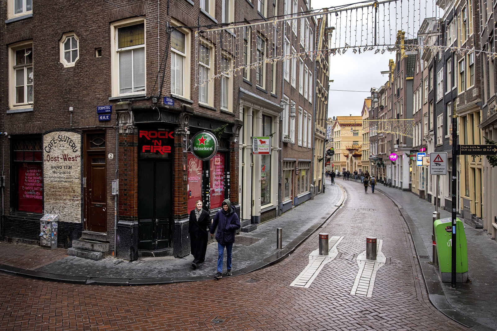 epa09649839 People walk around downtown Amsterdam during a coronavirus lockdown in the Netherlands, 19 December 2021. The Netherlands enforced a hard lockdown from 19 December 2021 until at least 14 January 2022 to curb the rapid spread of the Omicron variant of SARS-CoV-2.  EPA/Ramon van Flymen