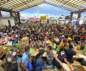 epa09652171 A handout photo made available by Greenpeace shows residents affected by typhoon Rai awaiting relief goods in San Juan village, Surigao City, southern Philippines, 20 December 2021 (issued 21 December 2021). Philippine National Police data show that the death toll from typhoon Rai rose to 375 and 56 are missing. More than 300,000 people were evacuated from their hom​es and beachfront resorts in central and southern Philippines.  EPA/ERWIN M. MASCARINAS HANDOUT  HANDOUT EDITORIAL USE ONLY/NO SALES