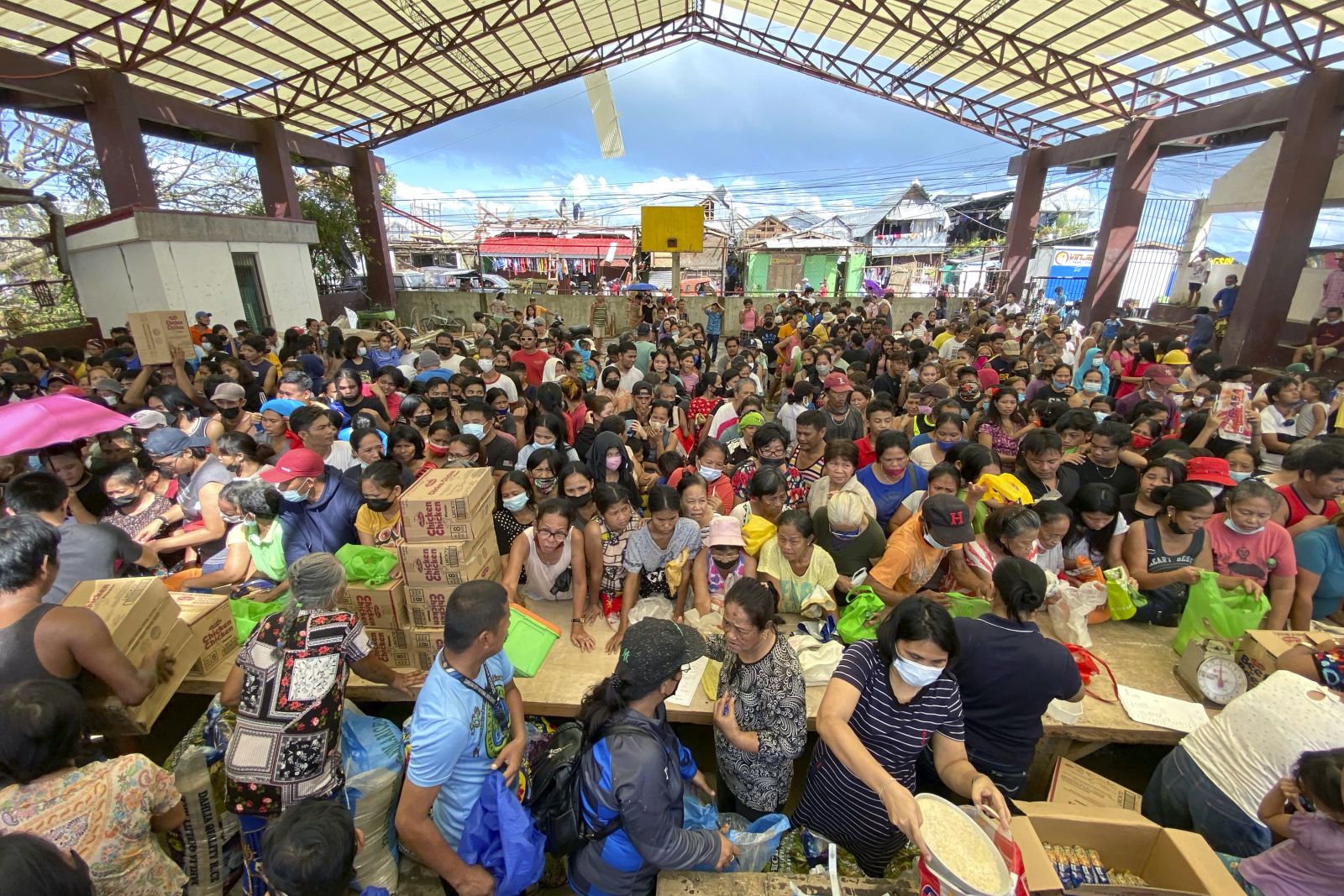 epa09652171 A handout photo made available by Greenpeace shows residents affected by typhoon Rai awaiting relief goods in San Juan village, Surigao City, southern Philippines, 20 December 2021 (issued 21 December 2021). Philippine National Police data show that the death toll from typhoon Rai rose to 375 and 56 are missing. More than 300,000 people were evacuated from their hom​es and beachfront resorts in central and southern Philippines.  EPA/ERWIN M. MASCARINAS HANDOUT  HANDOUT EDITORIAL USE ONLY/NO SALES