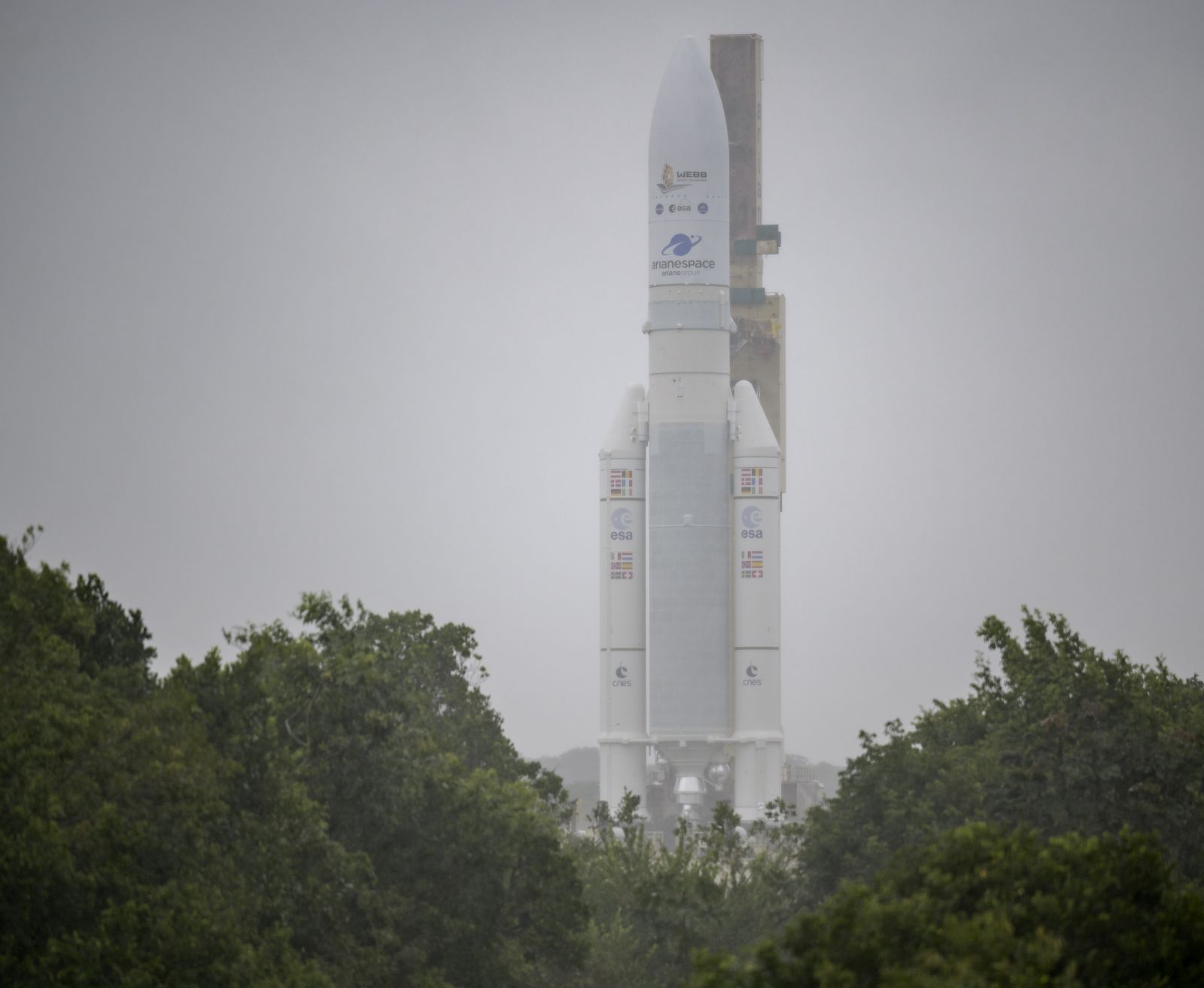 epa09655211 A handout photo made available by NASA shows Arianespace's Ariane 5 rocket with NASA’s James Webb Space Telescope onboard, being rolled out to the launch pad, at Europe’s Spaceport, the Guiana Space Center in Kourou, French Guiana, 23 December 2021. The James Webb Space Telescope (sometimes called JWST or Webb) is a large infrared telescope with a 21.3 foot (6.5 meter) primary mirror. The observatory will study every phase of cosmic history—from within our solar system to the most distant observable galaxies in the early universe.  EPA/NASA/Bill Ingalls HANDOUT MANDATORY CREDIT: (NASA/Bill Ingalls)

AFS 8/101 - Permanent HANDOUT EDITORIAL USE ONLY/NO SALES