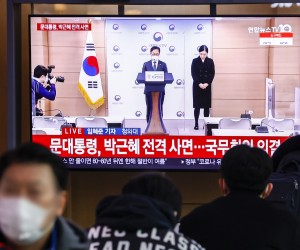 epa09655510 People watch a TV report about the government's announcement that former President Park Geun-hye, currently serving a 22-year prison term for corruption, was included among beneficiaries of President Moon Jae-in's special amnesty for the new year at Seoul Station, in Seoul, South Korea, 24 December 2021,  EPA/YONHAP SOUTH KOREA OUT