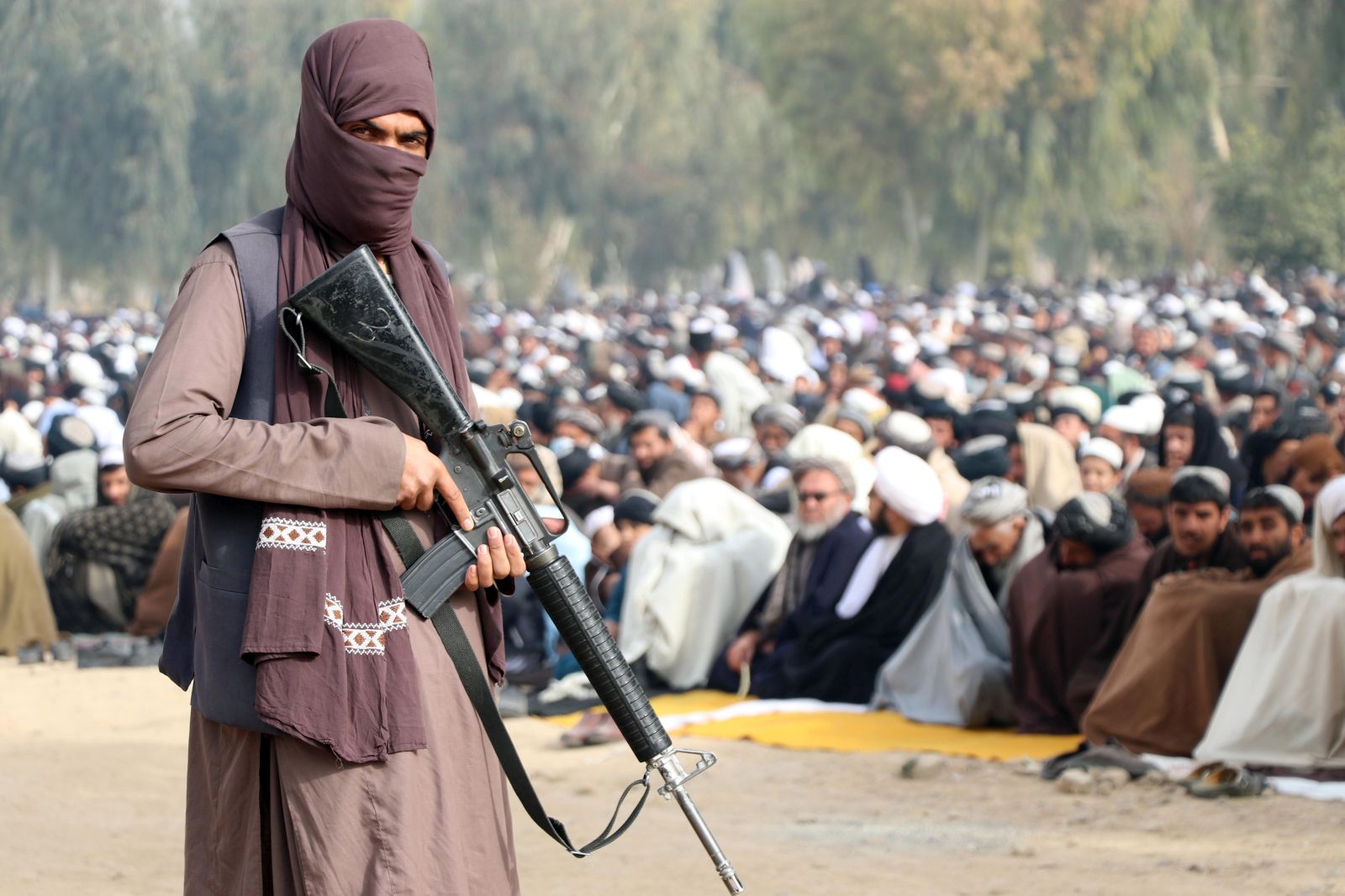 epa09656587 Taliban stand guard as Afghans gather to perform 'Istisqa' prayers, praying for rainfall as a drought has added misery to the already fragile economy of the country, in Kandahar, Afghanistan, 25 December 2021. Rain prayers, known in Arabic as Salat Al Istisqa, is a prayer observed by Muslims for asking and seeking rain from God. The World Food Program has warned that a humanitarian crisis of incredible proportions has grown even more complex and severe since the Taliban took control, and that 22.8 million Afghans – or more than half the population – are not consuming enough food.  EPA/STRINGER