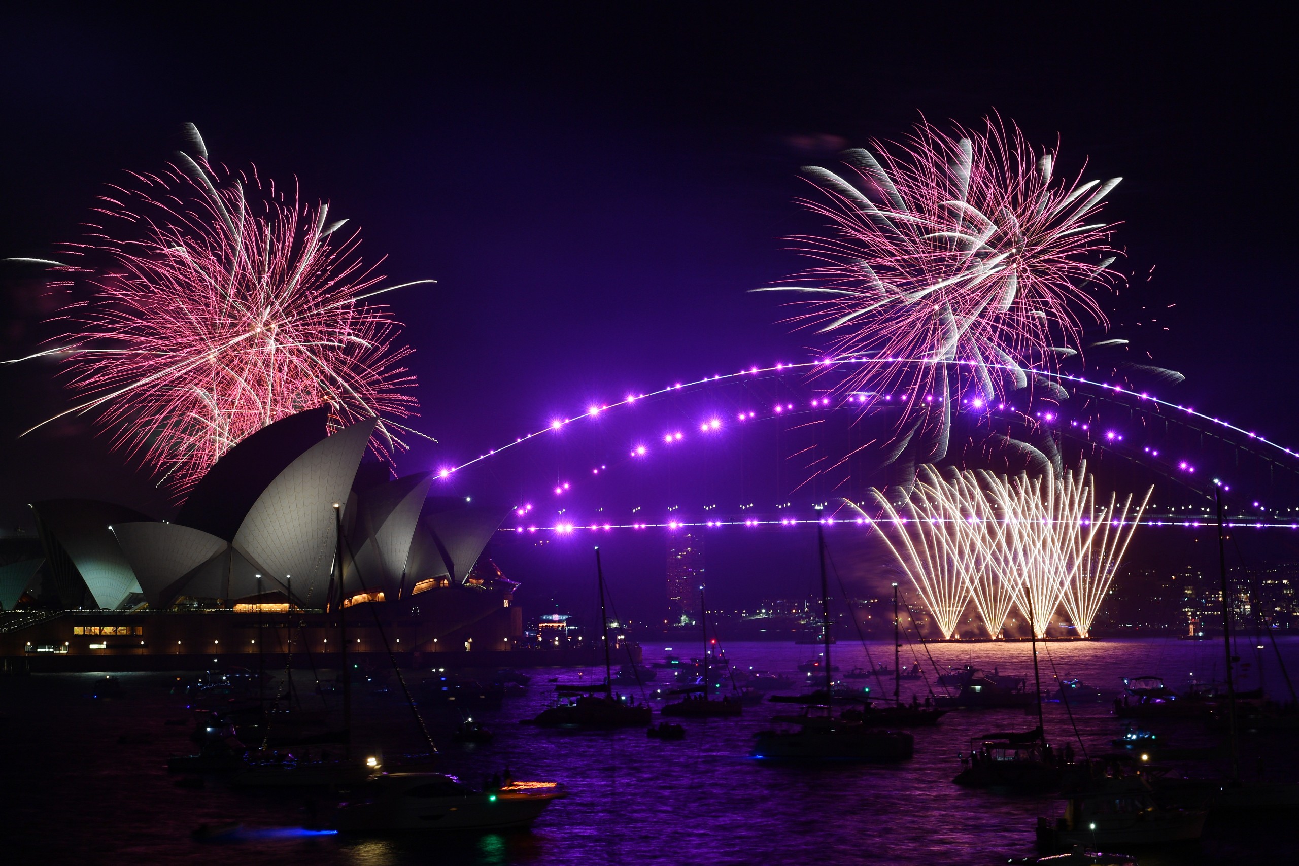 epa09661123 A view of the 9pm fireworks over the Sydney Opera House and Sydney Harbour Bridge during New Year's Eve celebrations in Sydney, New South Wales, Australia, 31 December 2021. Fireworks at 9pm and midnight in Sydney will be displayed against the backdrop of the Sydney Opera House and Sydney Harbour Bridge with crowd numbers expected to be low due to increasing COVID-19 case numbers in the country.  EPA/DEAN LEWINS AUSTRALIA AND NEW ZEALAND OUT
