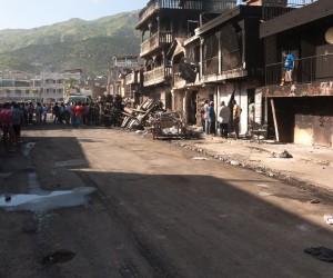 epa09642281 A street with damaged houses can be seen after a tanker explosion, which caused at least 60 deaths and dozens of injuries in Cap Haitien, Haiti, 14 December 2021. Haitian Prime Minister Ariel Henry traveled to Cap-Haitien, in the north of the country, to learn first-hand about the situation.  EPA/Johnson Sabin