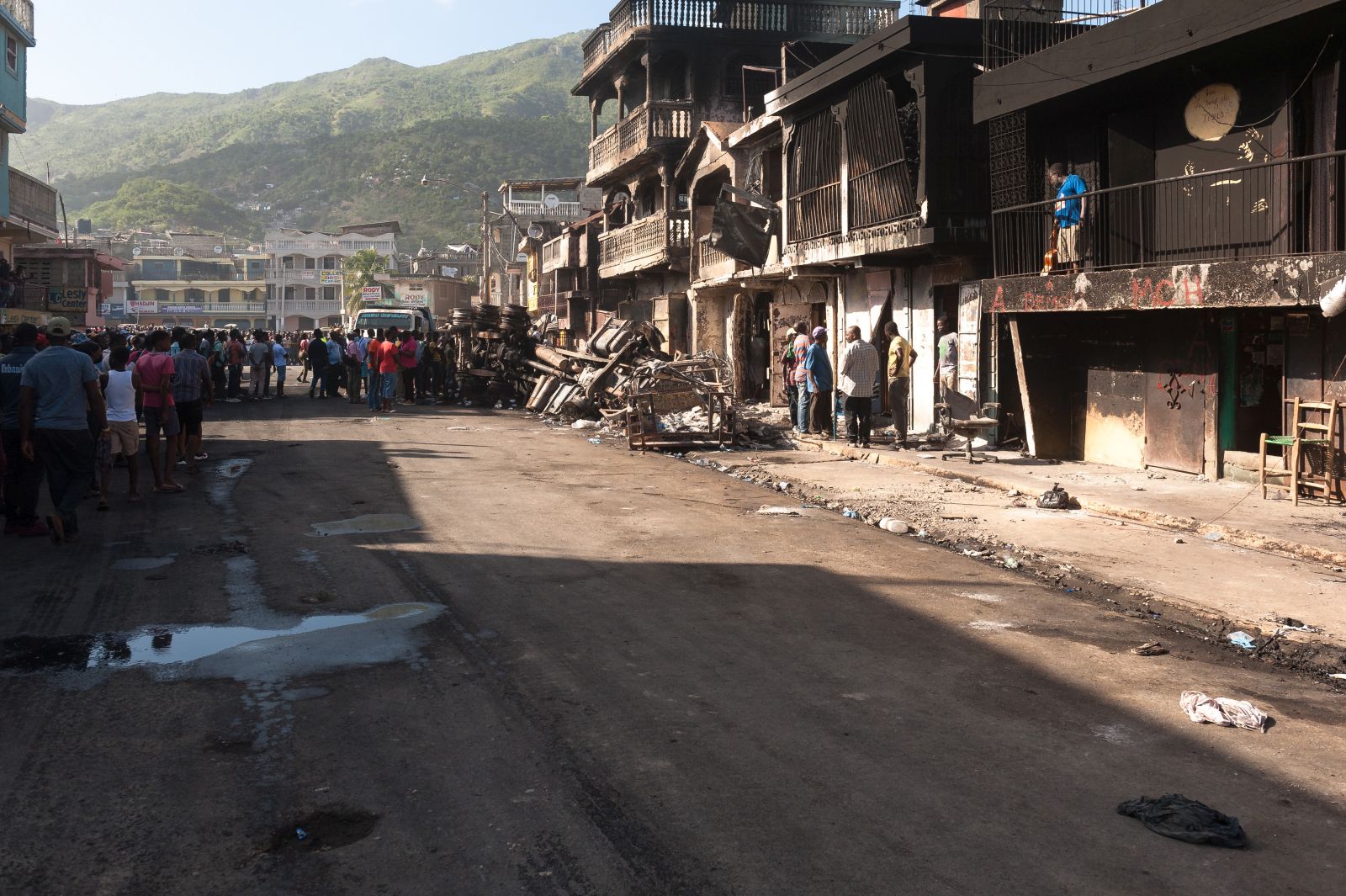 epa09642281 A street with damaged houses can be seen after a tanker explosion, which caused at least 60 deaths and dozens of injuries in Cap Haitien, Haiti, 14 December 2021. Haitian Prime Minister Ariel Henry traveled to Cap-Haitien, in the north of the country, to learn first-hand about the situation.  EPA/Johnson Sabin