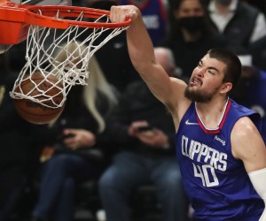 epa09652135 LA Clippers center Ivica Zubac scores against the San Antonio Spurs during the first quarter of the NBA basketball game between the Los Angeles Clippers and San Antonio Spurs at the Staples Center in Los Angeles, California, USA, 20 December 2021.  EPA/CAROLINE BREHMAN  SHUTTERSTOCK OUT