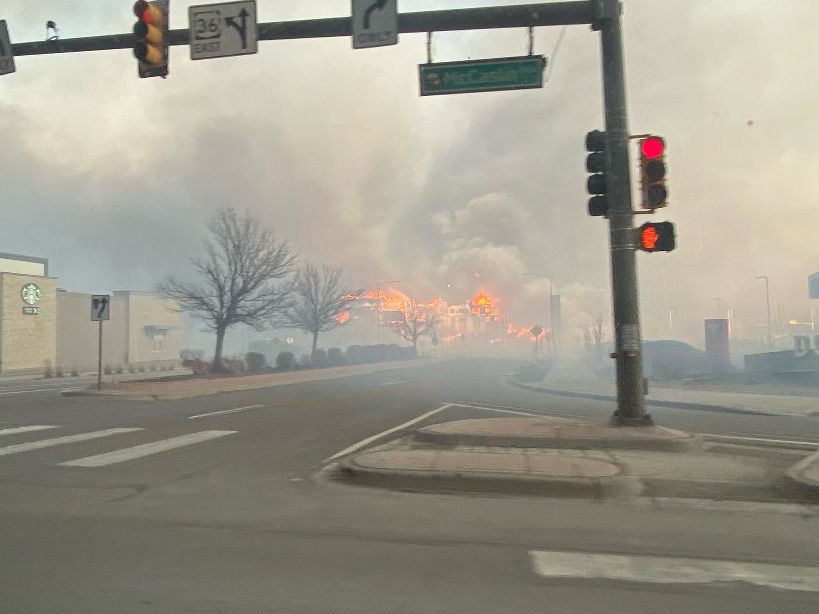 epa09661069 A handout photo made available by the Broomfield Police Department and taken by a patrol officers shows smoke and flames seen from McCaslin Blvd east of US 36 in Superior, Boulder County, Colorado, USA, 30 December 2021. Fast-moving wildfires, the Marshall and Middle Fork fires, on 30 December forced the evacuation of thousands of people in the towns of Louisville and Superior in Boulder County, Colorado. 'The fire activity is constantly changing and highly impacted by the weather,' the Boulder Office of Emergency Management (OEM) said in a statement.  EPA/BROOMFIELD POLICE DEPARTMENT HANDOUT -- BEST QUALITY AVAILABLE -- HANDOUT EDITORIAL USE ONLY/NO SALES