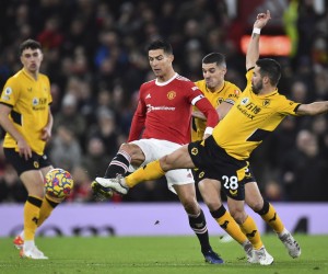 epa09664951 Manchester United's Cristiano Ronaldo (2-L) in action against Wolverhampton's Joao Moutinho (R) during the English Premier League match between Manchester United and Wolverhampton Wanderers in Manchester, Britain, 03 January 2022.  EPA/PETER POWELL EDITORIAL USE ONLY. No use with unauthorized audio, video, data, fixture lists, club/league logos or 'live' services. Online in-match use limited to 120 images, no video emulation. No use in betting, games or single club/league/player publications