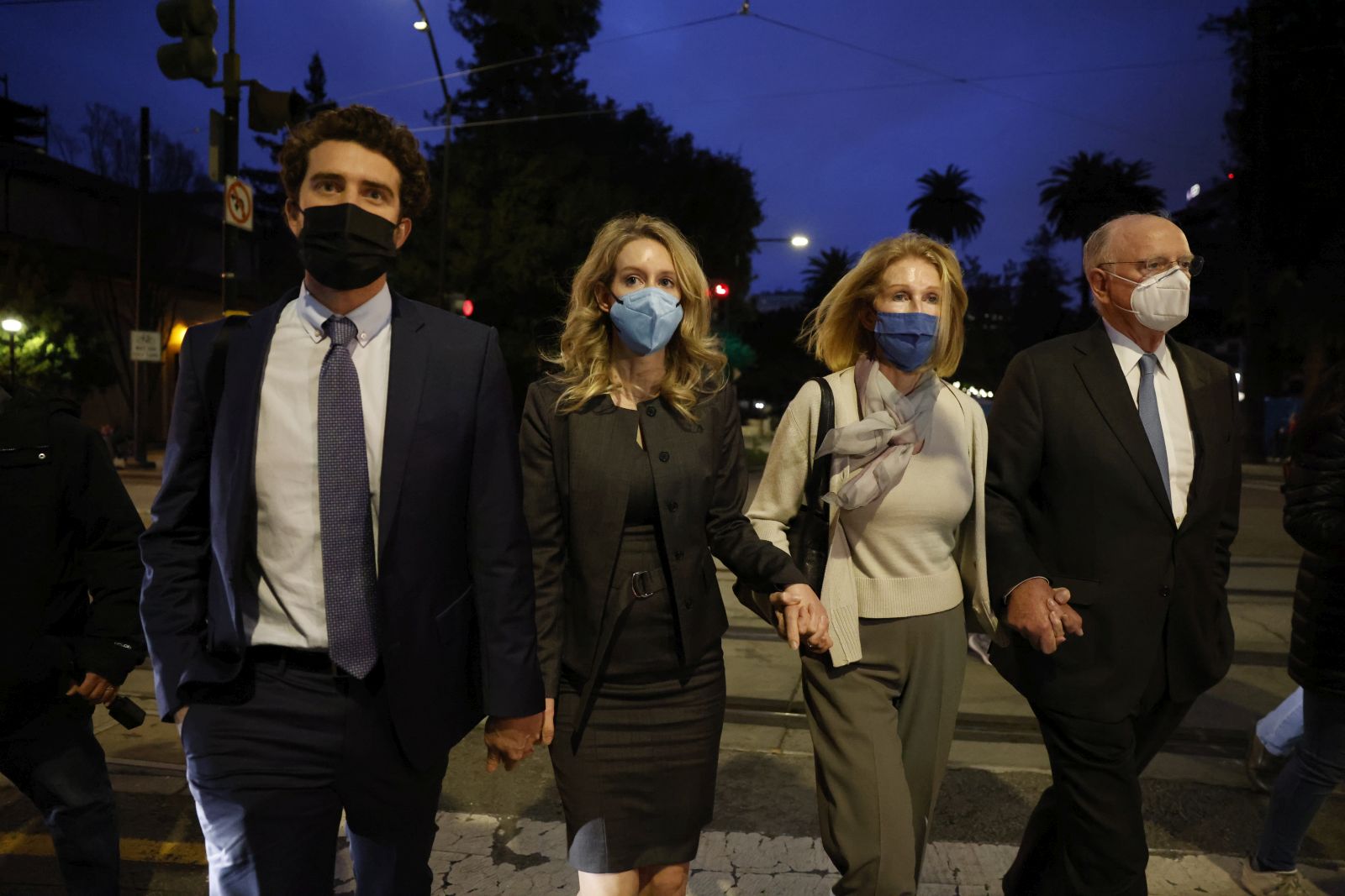 epa09665287 Elizabeth Holmes (2-L), founder of Theranos, her partner, Billy Evans (L), her mother Noel (2-R) and her father Christian (R) depart the Robert F. Peckham Federal Building and US Courthouse after being found guilty on four counts and acquitted on four counts in San Jose, California, USA, 03 January 2022. The jury also deadlocked on three other charges against CEO Elizabeth Holmes, and Theranos, her failed blood-testing technology start-up company.  EPA/PETER DASILVA