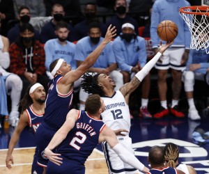 epa09665330 Memphis Grizzlies guard Ja Morant (R) puts up a shot past a defending Brooklyn Nets forward Bruce Brown (L) and teammate Brooklyn Nets forward Blake Griffin (C) in the second half of the NBA game between the Memphis Grizzlies and the Brooklyn Nets at the Barclays Center in Brooklyn, New York, USA, 03 January 2022.  EPA/JASON SZENES  SHUTTERSTOCK OUT