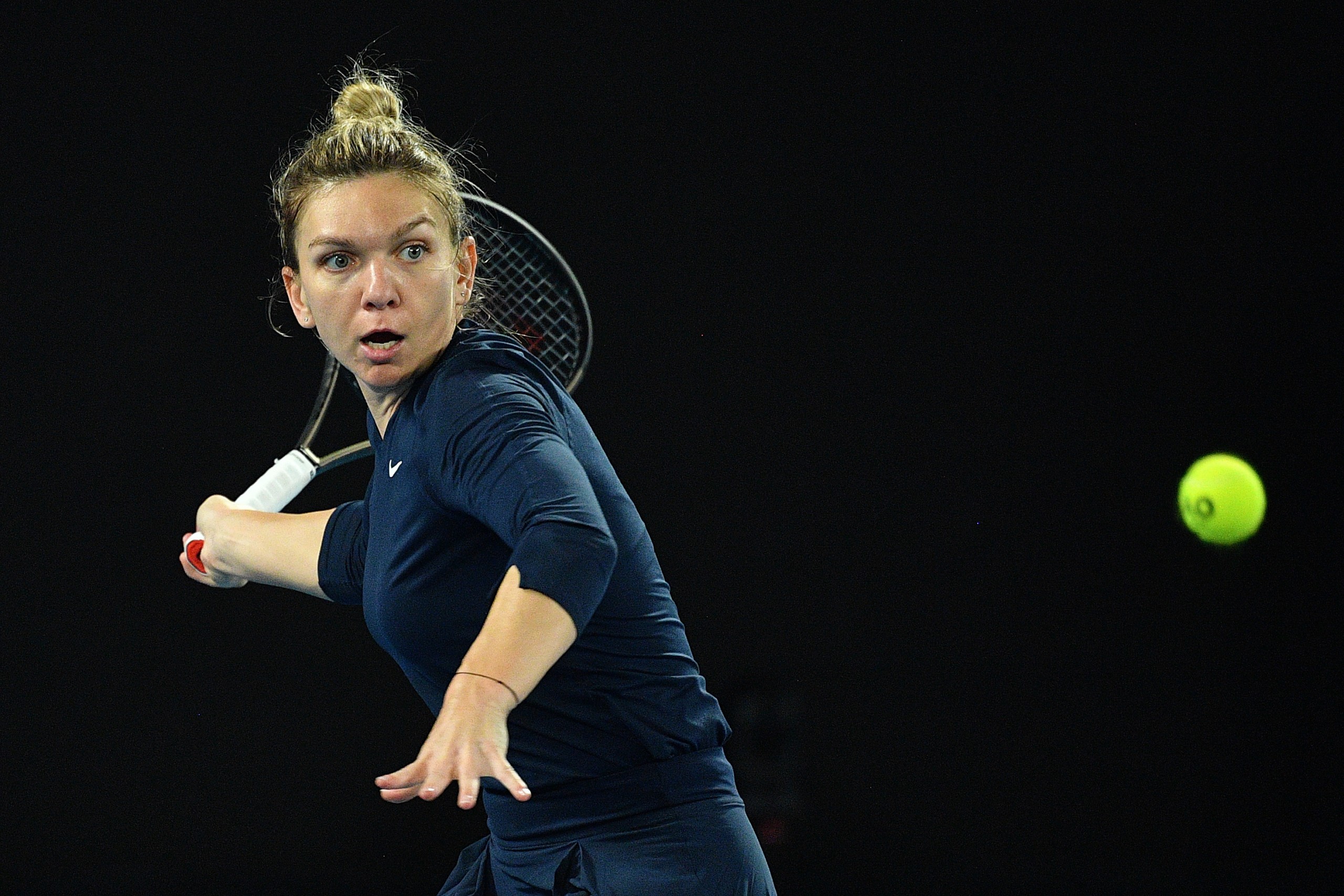 epa09671134 Simona Halep of Romania in action during her match against Viktorija Golubic of Switzerland on day five of the Melbourne Summer Set tennis tournament at Melbourne Park in Melbourne, Australia, 07 January 2022.  EPA/JAMES ROSS  AUSTRALIA AND NEW ZEALAND OUT